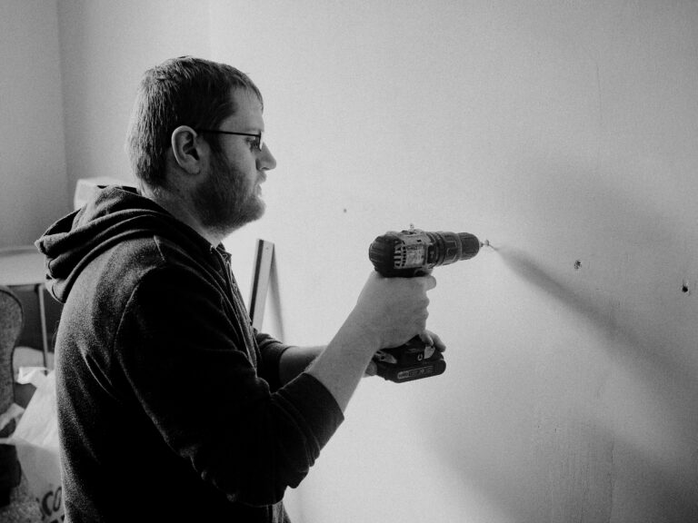 free-photo-of-man-drilling-wall-in-house